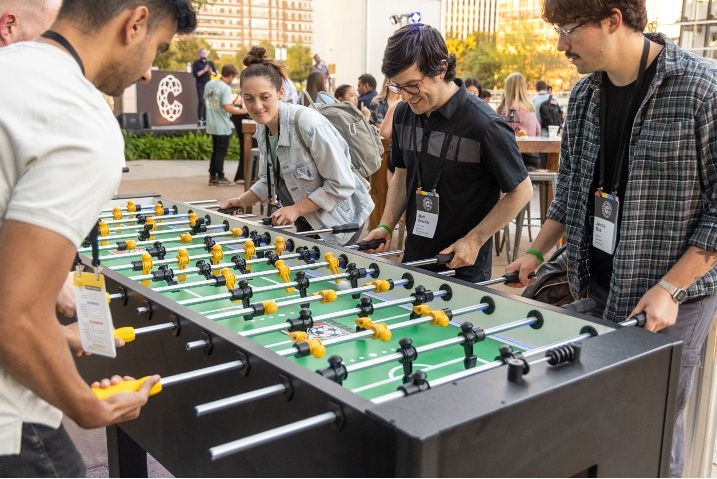 Coalition employees playing foosball at the office.