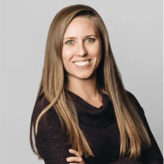 Headshot of Kelly Burdine, Director of Data and Analytics at Wellthy, looking at the camera and smiling.