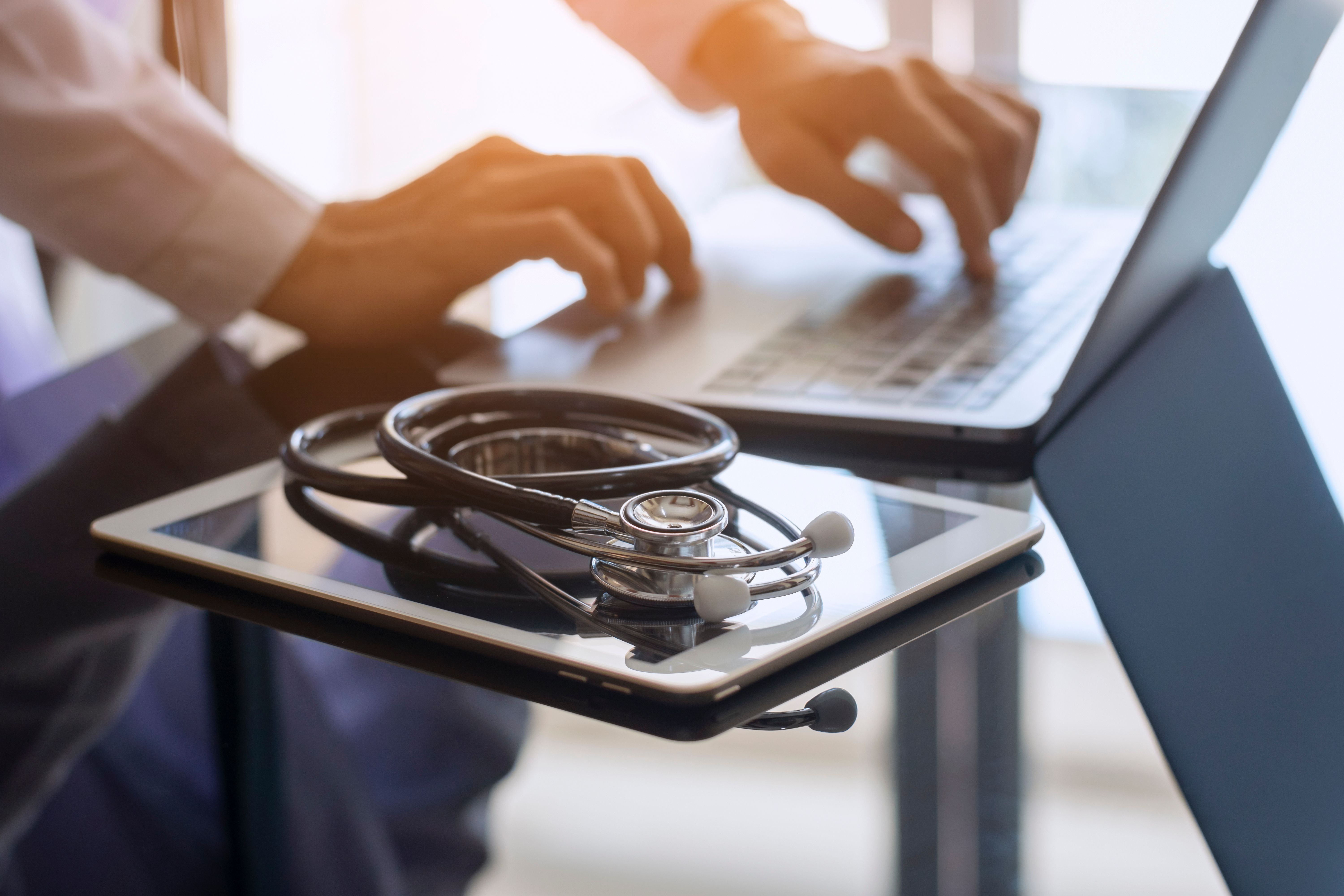 Telehealth with laptop, tablet, and stethoscope | Image credit: NIKCOA - stock.adobe.com.jpg