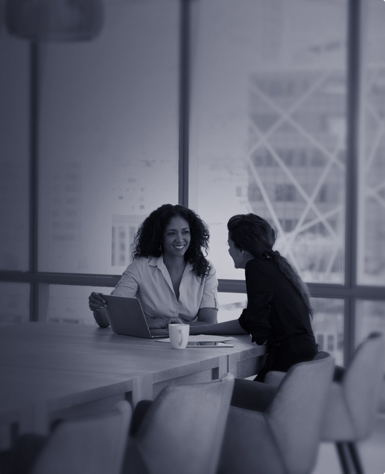 Two women discuss business