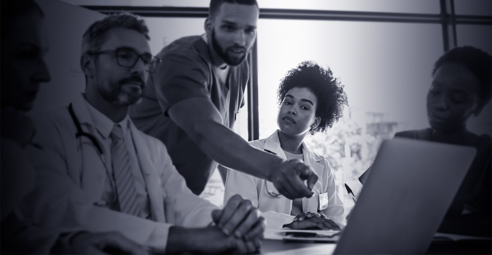 A sales rep pointing out information to 2 doctors