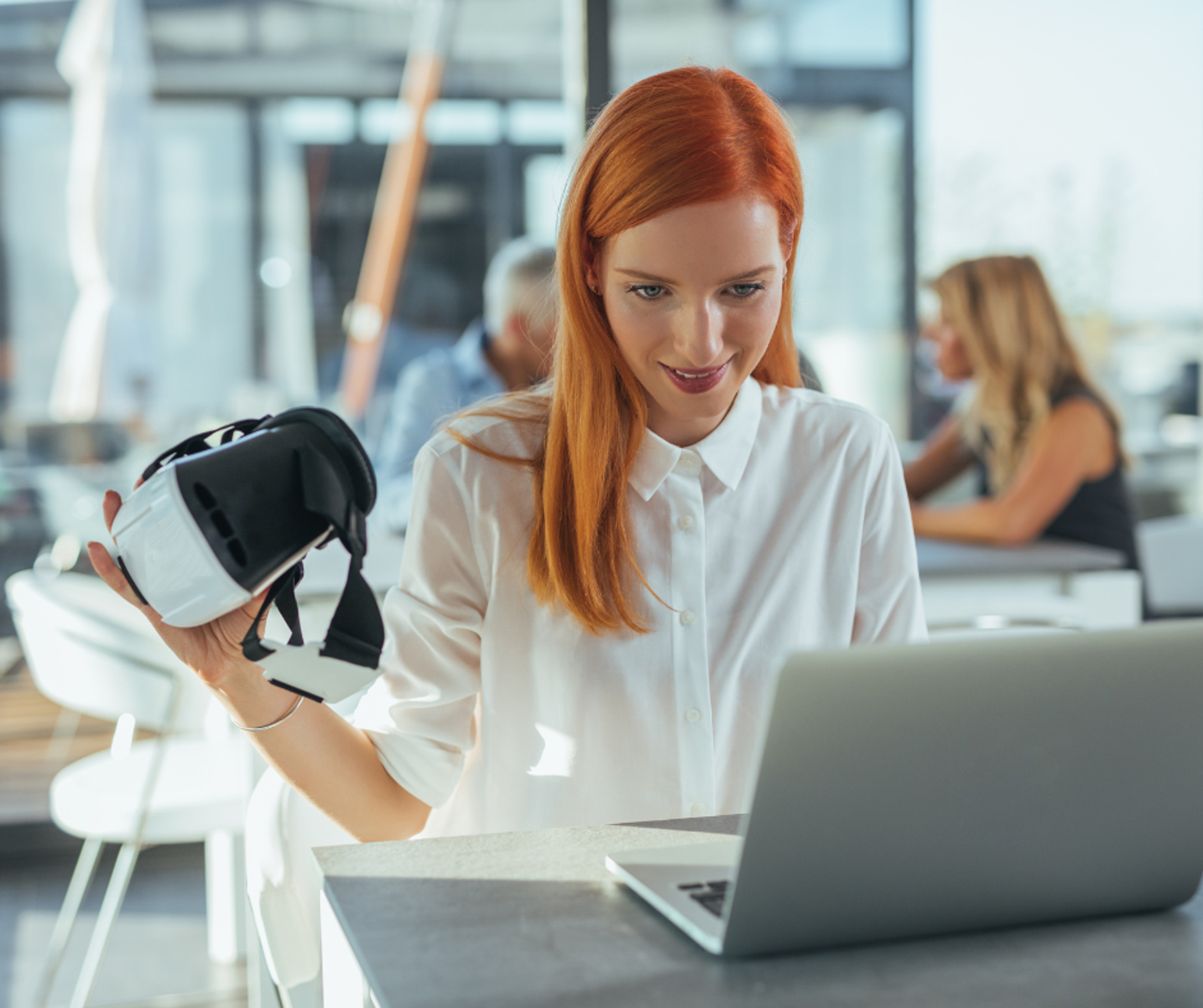 woman on computer with VR set