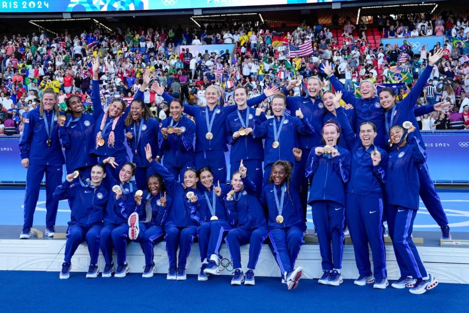 The USWNT with gold medals on the podium after the 2024 Olympic Gold Medal match