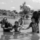 image of people wading through water