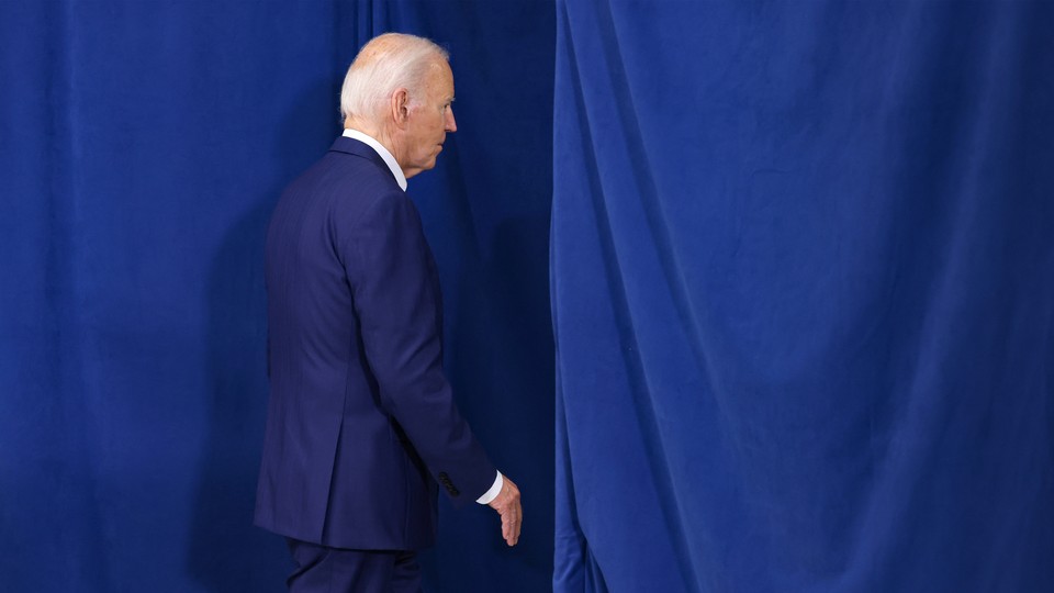 A photo of Biden leaving a stage