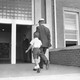 A man and his son walking into a school