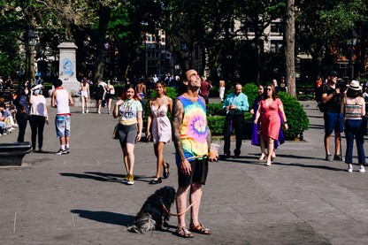 a person with a dog in Washington Square Park in May of 2021