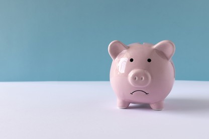 A piggy bank with a frowning face