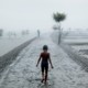 A child walking on a path near water.