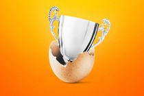 Photo-illustration of a silver trophy popping out of an egg shell