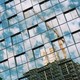 A reflection of a crane constructing new buildings