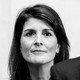 Black and white photo with Nikki Haley in the background and part of Donald Trump's face in the foreground