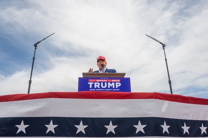 Donald Trump speaks from a podium during his campaign rally