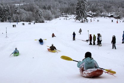 People compete during a snow-kayak downhill race near Otepää, Estonia, in 2013.