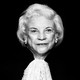 A black-and-white portrait of Sandra Day O’Connor, wearing her robes and facing the camera