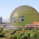 A huge dome, covered in LED lights, displays the eyes and mouth of an emoji face.