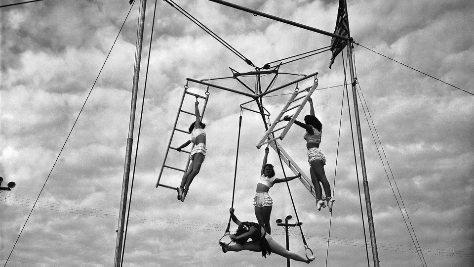 black and white photograph of circus women on rings