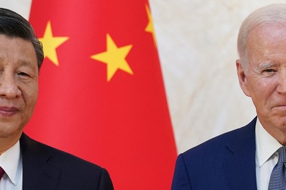 A photograph of Chinese leader Xi Jinping and U.S. President Joe Biden in front of a Chinese flag