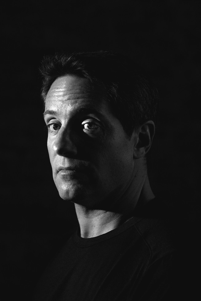 black-and-white photo portrait of Carson Block against black background