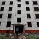 A worker passes a building, which is part of the old five-story apartment blocks demolition project launched by the city authorities, in Moscow, Russia.
