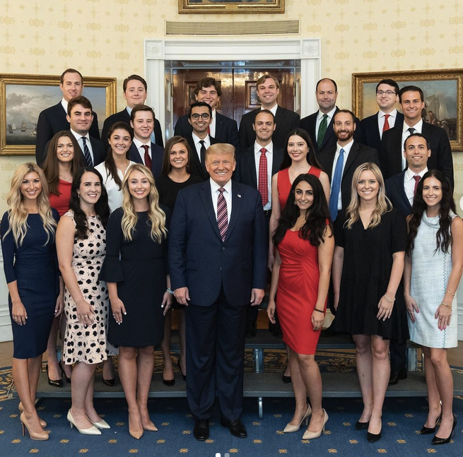 Trump standing with members of his office. 