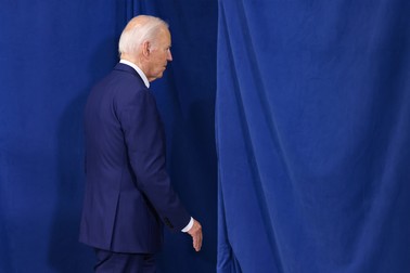 A photo of Biden leaving a stage