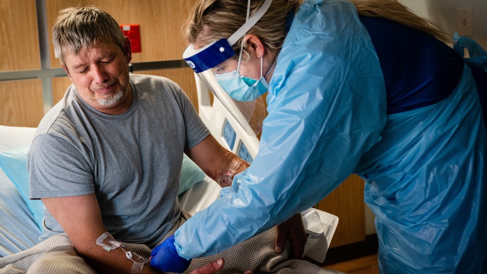 A nurse and a COVID-19 patient UAMS​ Medical Center in Little Rock​, Ark., July 9, 2021