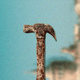 A hammer against a blurred landscape background