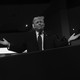 Black-and-white photo of Donald Trump at the RNC with his hands out