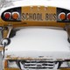 A school bus covered in snow.