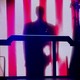 Donald Trump's shadow is illuminated on the stripes of the American flag during a keynote address in Detroit
