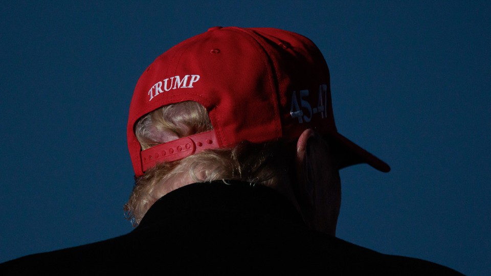 A photo of Donald Trump wearing a MAGA cap.