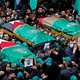 A crowd bears up Palestinian-flag-draped coffins at the funeral of Saleh al-Arouri