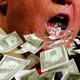 A close-up of Donald Trump's mouth appearing to suck up or exhale cash