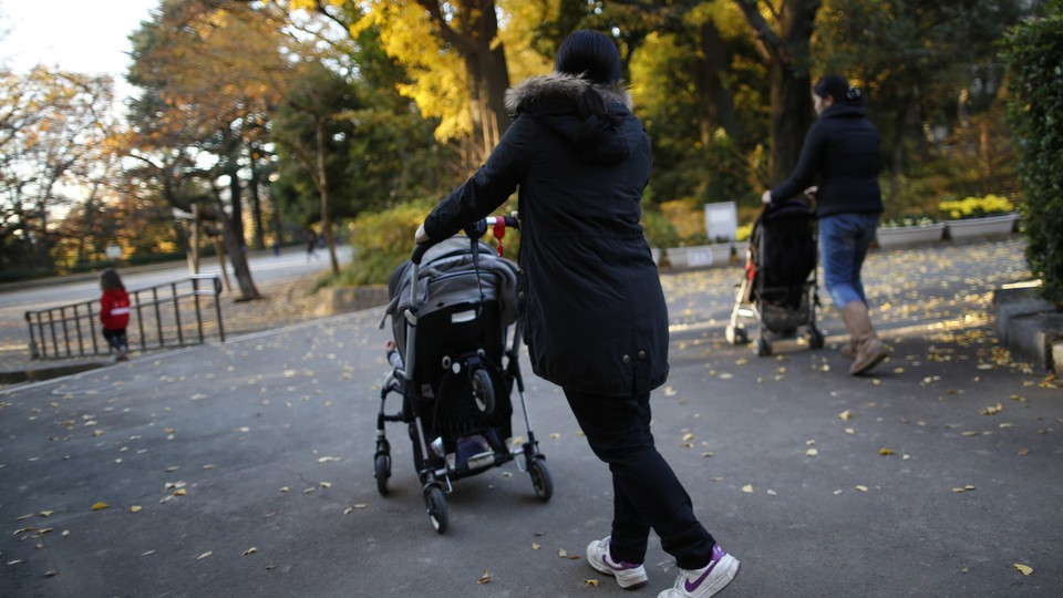 A photograph of a woman with a stroller