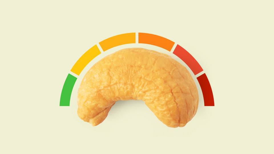 A cashew with a rating system curving above it, ranging from green to red.