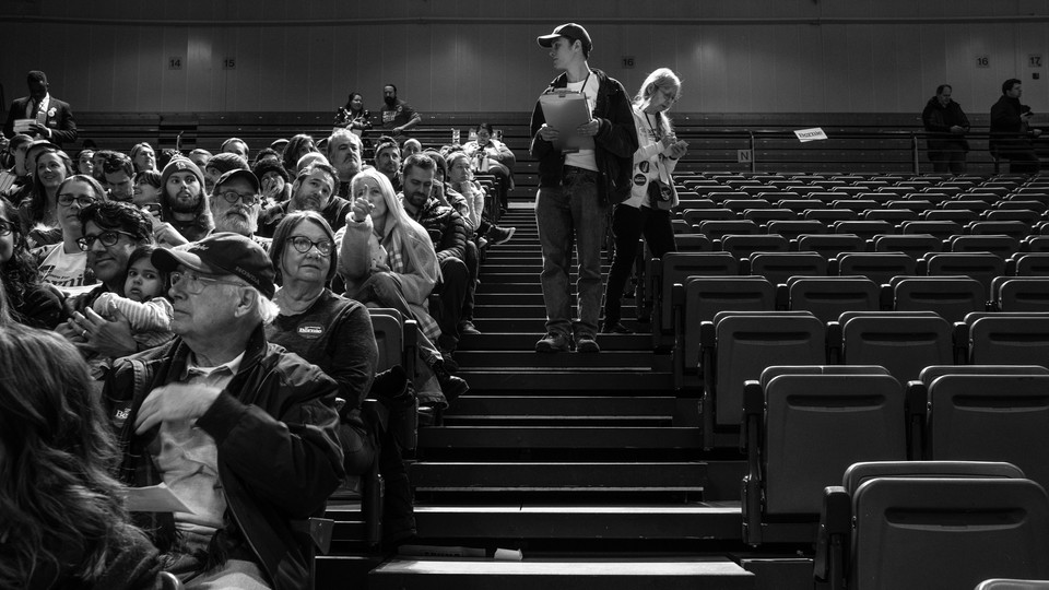 A black-and-white photo of Iowans caucusing