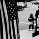 a mother and children walking in front of an American flag