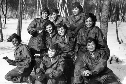 A group of 9 African American women in uniform smile for a group photo