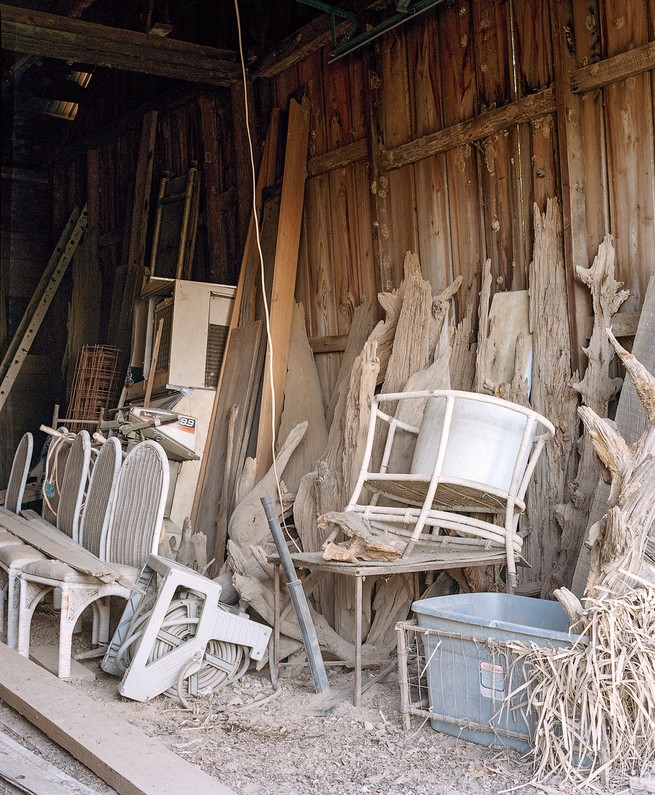 photo of inside the barn, with dusty furniture and other storage
