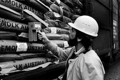 A specialist measures the radioactivity of freight cars full of contaminated milk powder