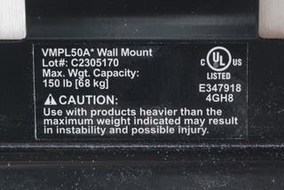 Closeup of a sticker on a TV mount showing a 150lb weight capacity.