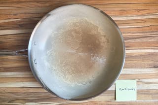 Top-view of the inside of the Goldilocks skillet with browned flour in the center of it.