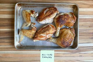 A sheet pan with pieces of chicken browned and cooked in the 12-inch All-Clad D3 Stainless Everyday 3-Ply Bonded Skillet.