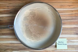 Top-view of the inside of the Thomas Keller Insignia pan with browned flour evenly distributed in it.