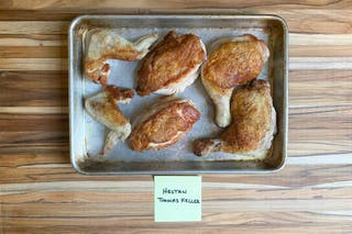 A sheet pan with pieces of chicken browned and cooked in the 12.5-inch Hestan’s Thomas Keller Insignia sauté pan.