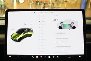 The tesla display screen as seen from the inside of the car, displaying the battery charging information.