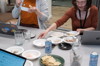 A view of two people tasting samples of vegan ice cream from various bowls.