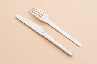 The knife and fork of the Heath Ceramic Muir Flatware set.