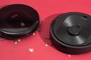 Eufy Roborock robot vacuum side by side with a few cheetos next to them.